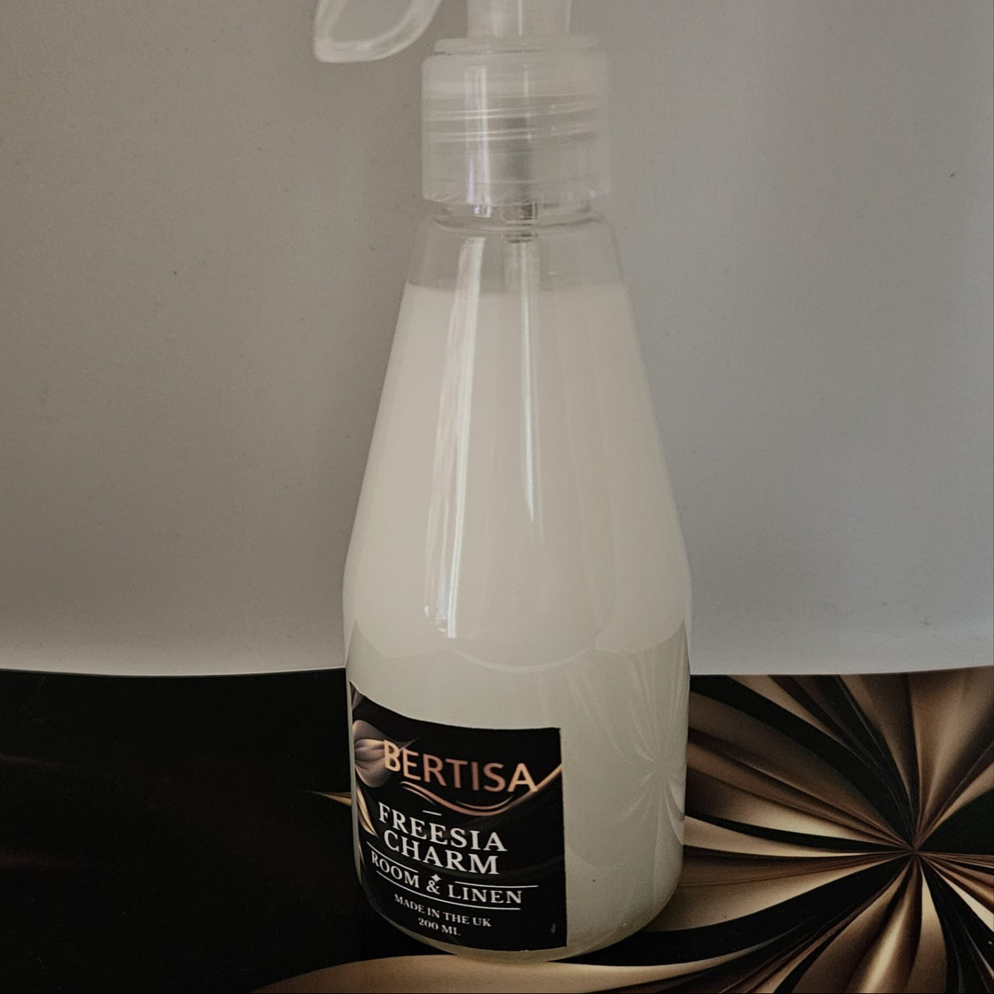 Bertisa Freesia Charm room and linen spray bottle on a decorative surface