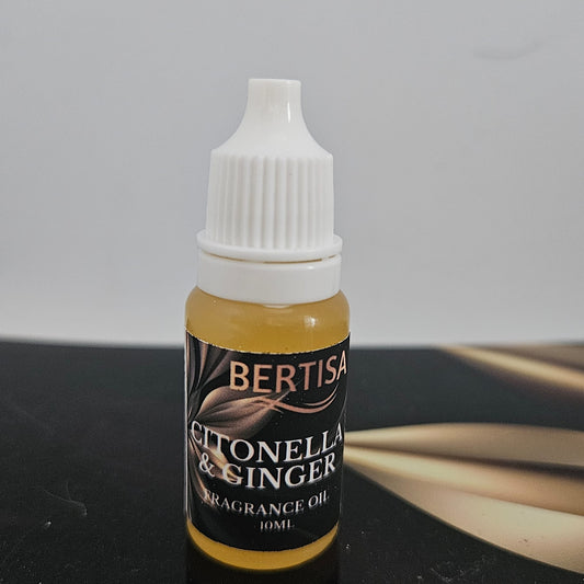 Bottle of Bertisa Citronella & Ginger fragrance oil on a dark surface with a gray background