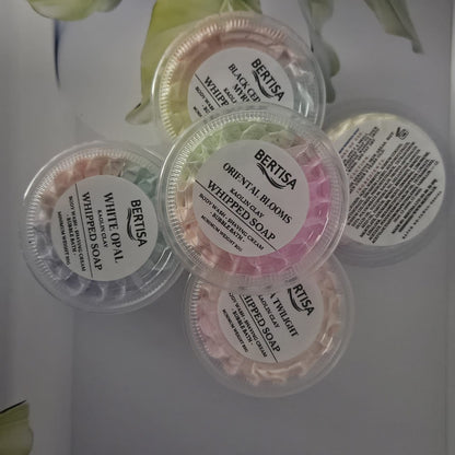 Four containers of Bertisa whipped soap on a white background