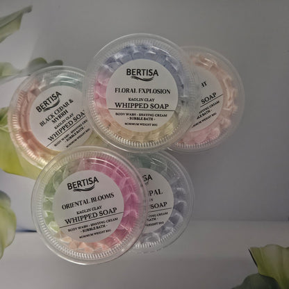 Four containers of Bertisa whipped soap with floral designs on a light background