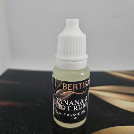 Bottle of Bertisa Banana Hot Rum fragrance oil on a dark surface with a light gray background