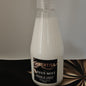 Bottle of Bertisa Lotus Mist Room & Linen spray on a neutral background