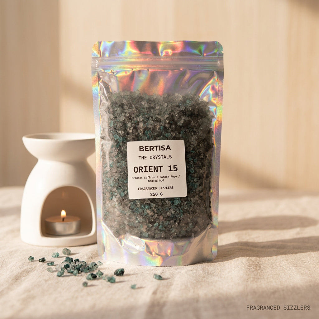 Holographic Orient 15 fragranced sizzlers pouch, 250g, with scattered crystals and a candle in the background