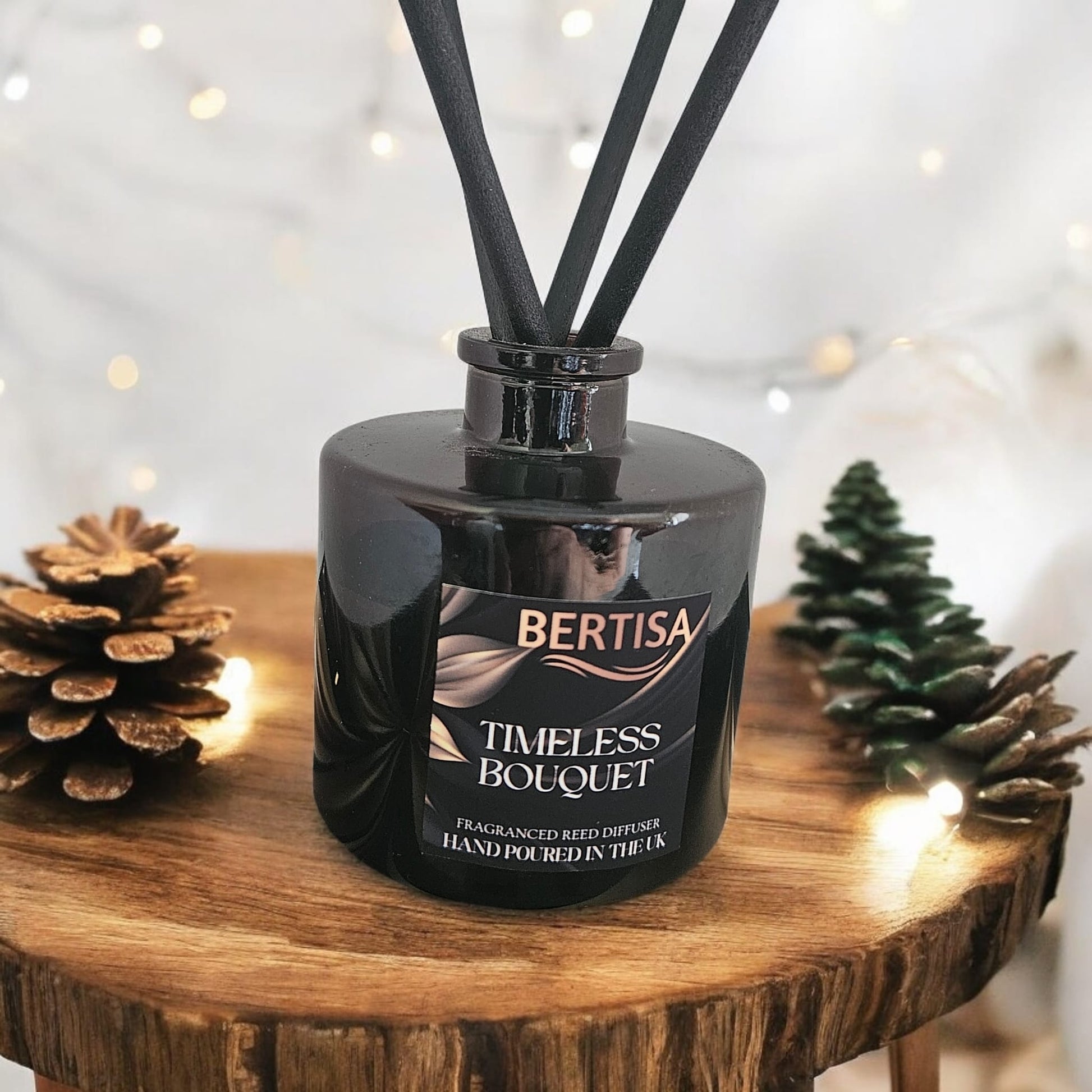 Black Bertisa Timeless Bouquet diffuser on a wooden surface with decorative elements.