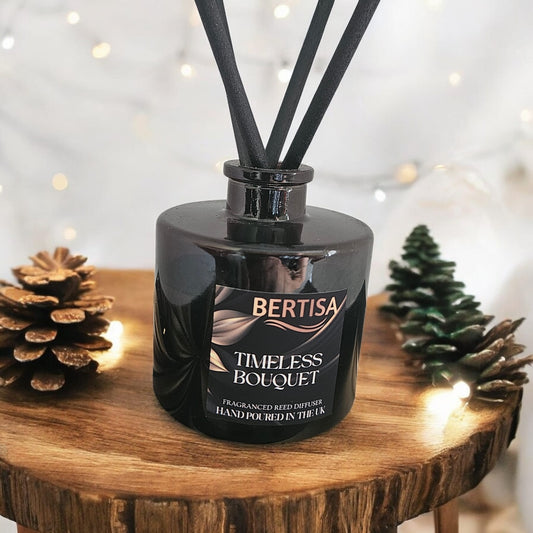 Black Bertisa Timeless Bouquet diffuser on a wooden surface with decorative elements.