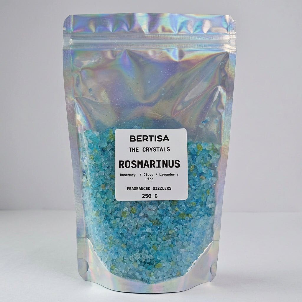 A stand-up pouch of Bertisa The Crystals Rosmarinus fraganced sizzlers, filled with light blue and green salt crystals, with a white label on a white background.