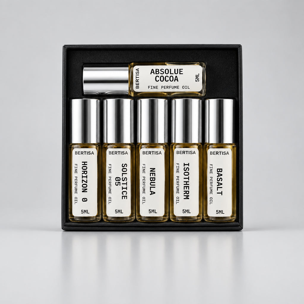 Collection of Bertisa perfume bottles in a black display case with a dark background