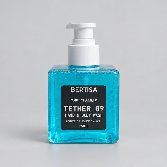 Blue bottle of BERTISA hand and body wash on a beige background