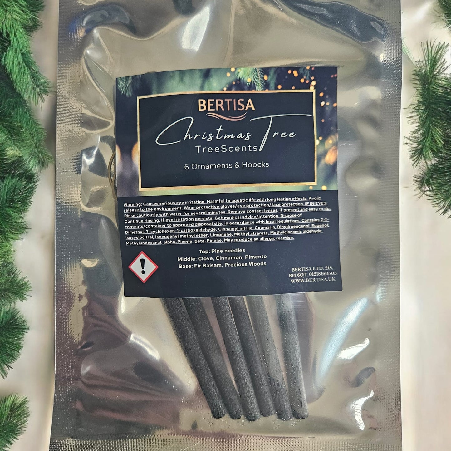 Packaged Christmas tree scents with Bertisa branding on a decorative background